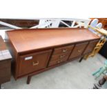 A RETRO TEAK SIDEBOARD ENCLOSING THREE DRAWERS AND THREE CUPBOARDS, 78" WIDE