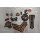 A QUANTITY OF MILITARY CLOTH BADGES AND PIPS