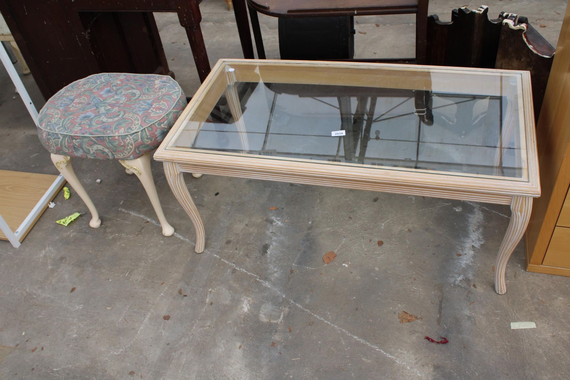 A LIMED COFFEE TABLE WITH GLASS TOP AND A STOOL ON CABRIOLE LEGS