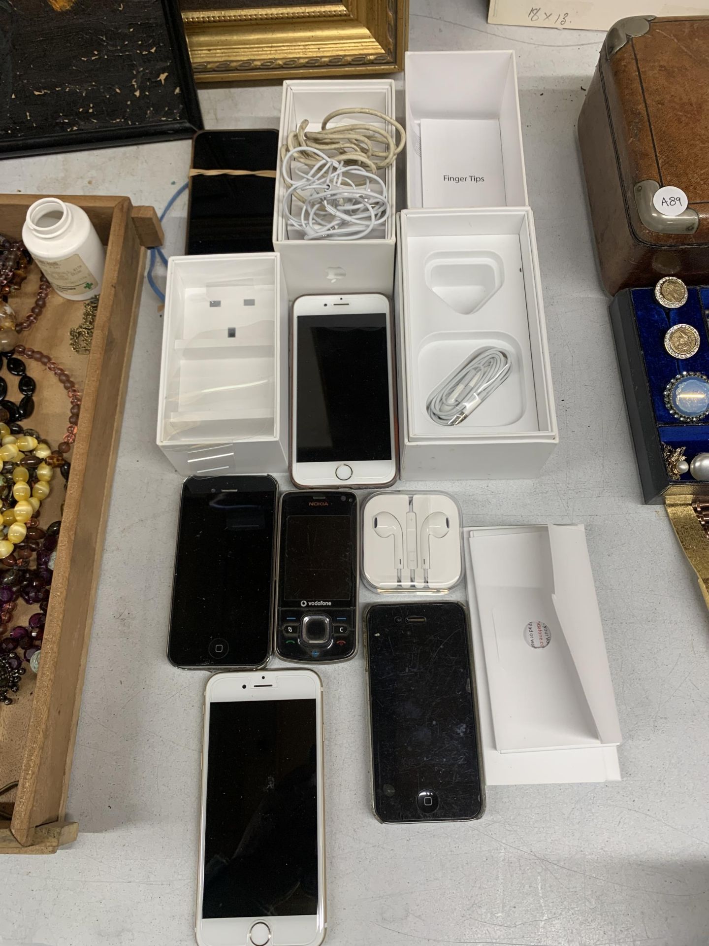 SIX USED MOBILE PHONES TO INCLUDE FIVE I-PHONES AND ONE NOKIA, PLUS EARPHONES AND ONE CHARGER