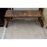 AN OAK PIG BENCH STYLE COFFEE TABLE 37" X 12"