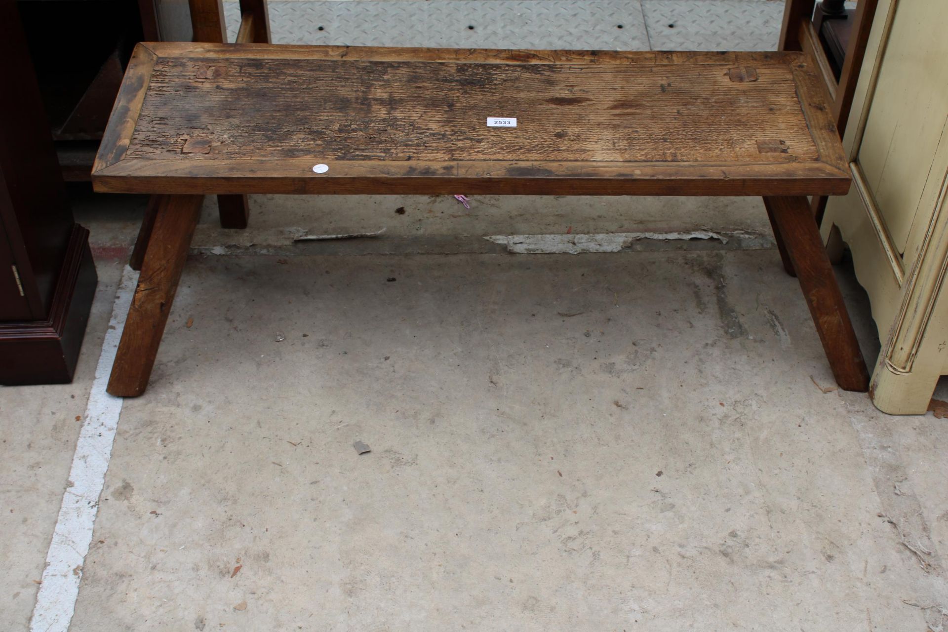 AN OAK PIG BENCH STYLE COFFEE TABLE 37" X 12"