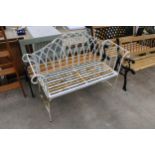 A DECORATIVE METAL TWO SEATER GARDEN BENCH