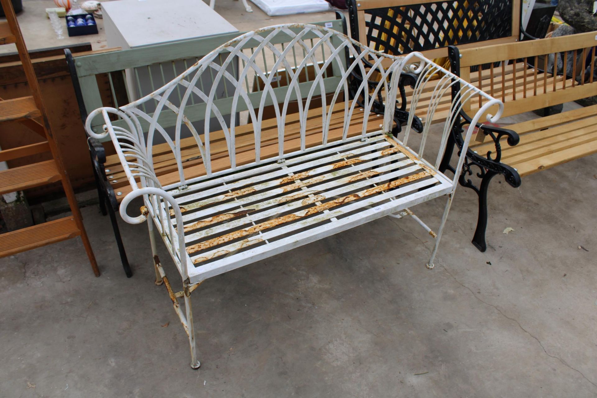A DECORATIVE METAL TWO SEATER GARDEN BENCH