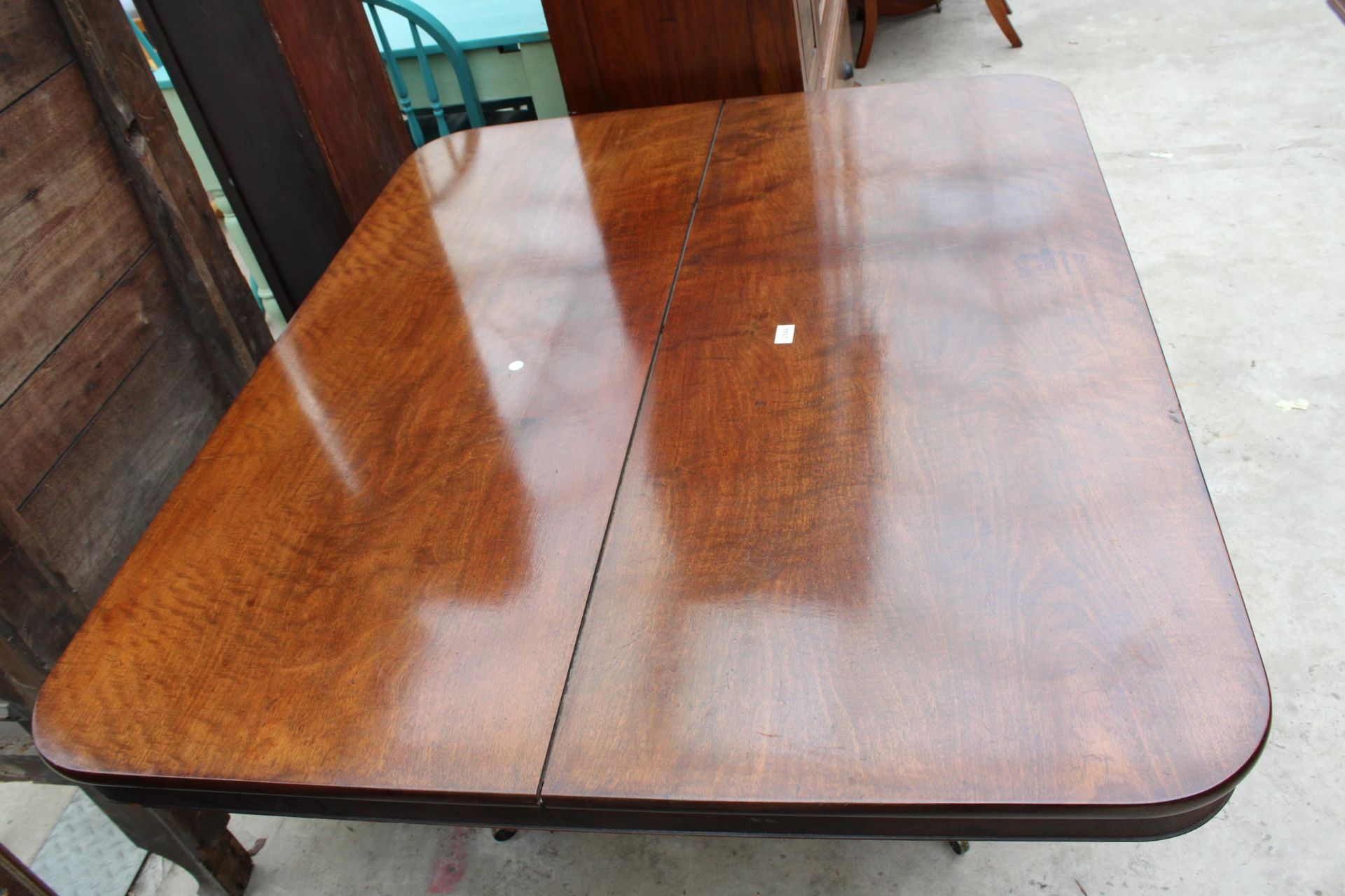 A REGENCY STYLE MAHOGANY PEDESTAL TILT-TOP DINING TABLE 56" X 46.5" WITH BRASS FEET AND CASTERS - Image 3 of 3