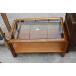 A RETRO TEAK REMPLOY TWO TIER COFFEE TABLE WITH GLASS TOP, 31" X 19"