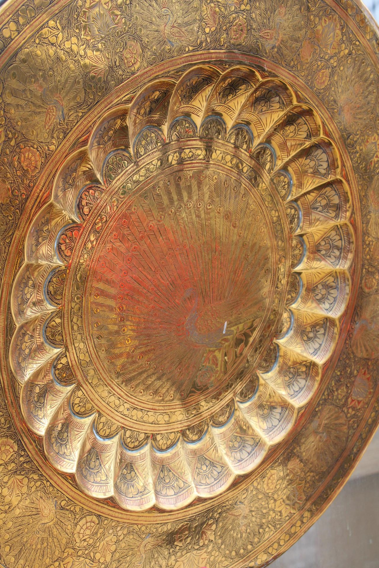 A LARGE BRASS WALL CHARGER DEPICTING A PEACOCK - Image 2 of 2