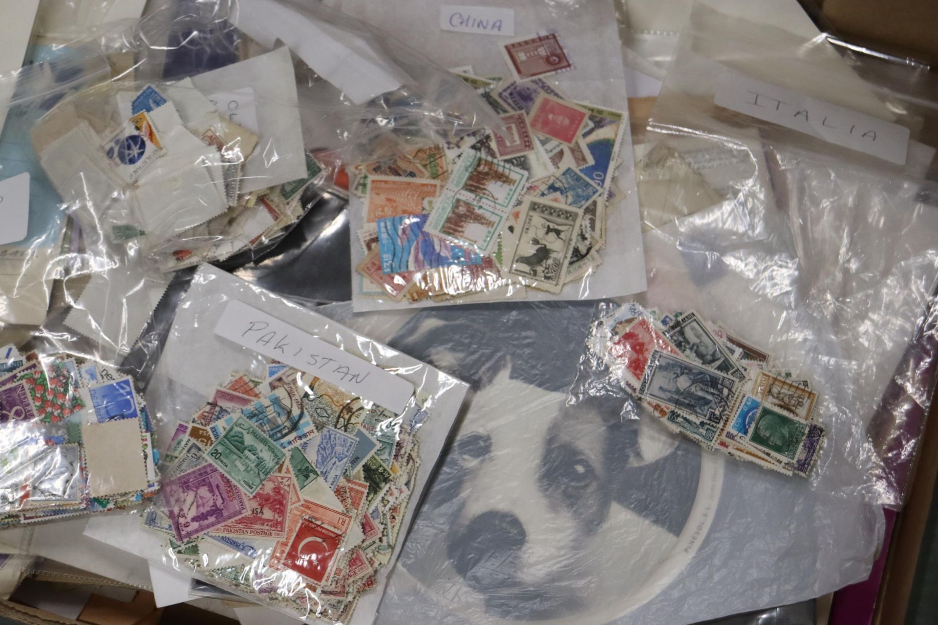 A LARGE QUANTITY OF USED STAMPS ON ENVELOPES AND STAMPS TO INCLUDE SPAIN, CANADA, MALTA, ETC.,