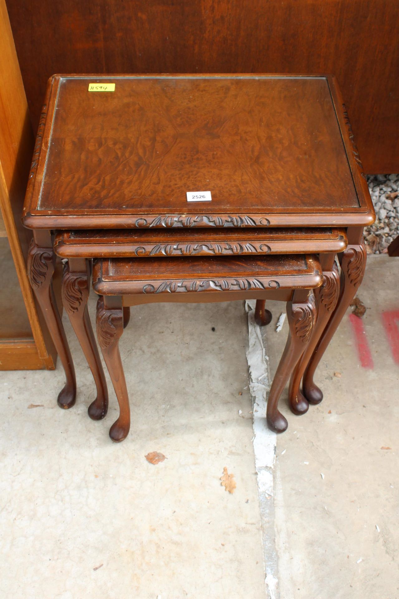 A MAHOGANY NEST OF THREE TABLES ON CABRIOLE LEGS