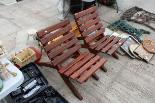 A PAIR OF FOLDING WOODEN GARDEN CHAIRS