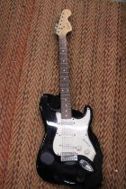 A SQUIER BLACK STRATOCASTER ELECTRIC GUITAR BY FENDER