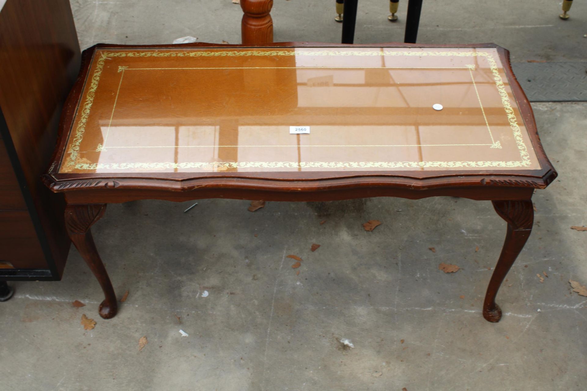 A MAHOGANY COFFEE TABLE WITH INSET LEATHER TOP ON CABRIOLE LEGS