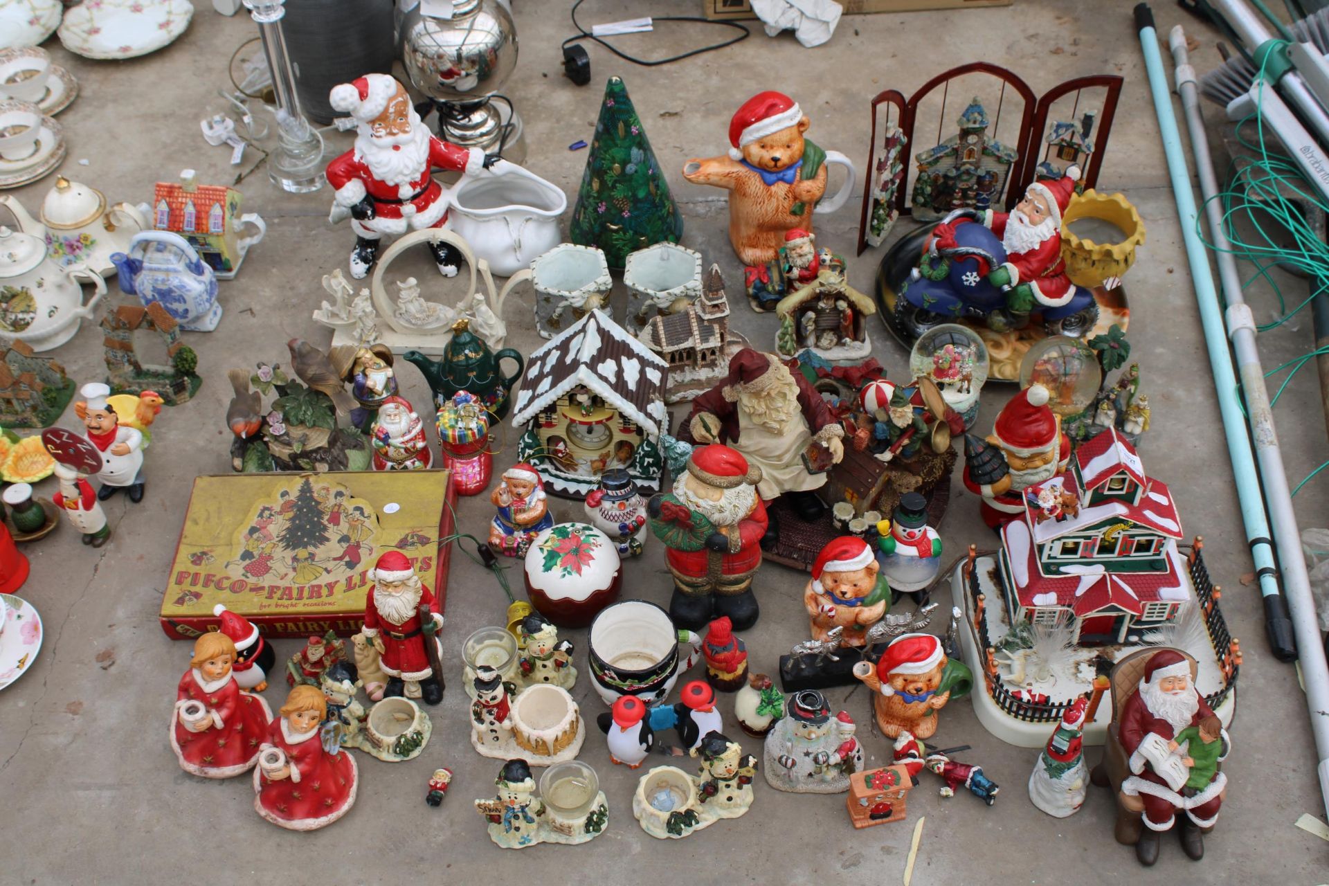A LARGE ASSORTMENT OF CHRISTMAS DECORATIONS TO INCLUDE SANTA FIGURES, ORNAMENTS AND PLANTERS ETC