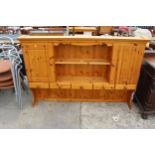 A PINE DRESSER RACK ENCLOSING CUPBARDS AND DRAWERS, 72" WIDE