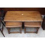 AN ERCOL BLONDE NEST OF THREE TABLES
