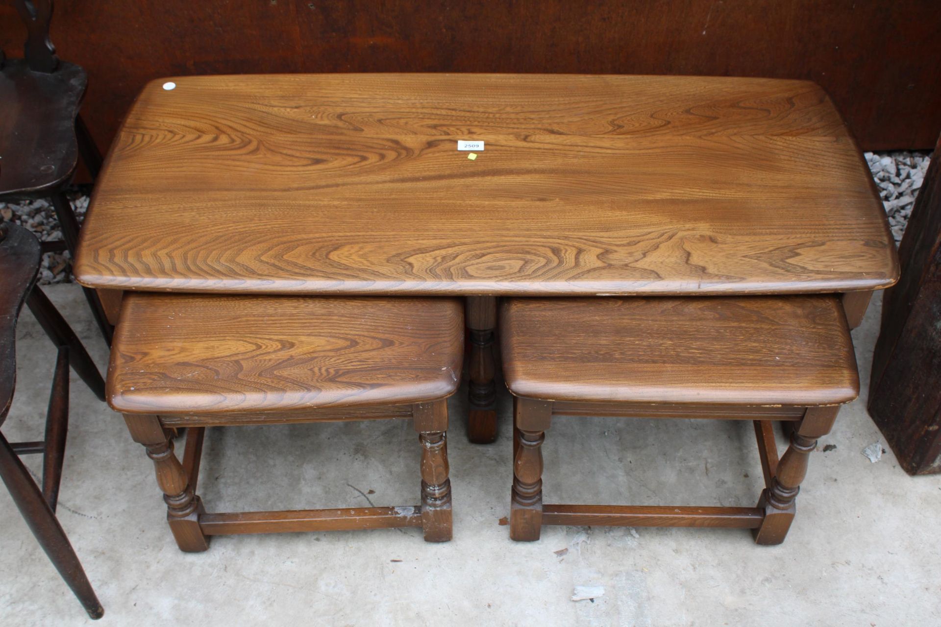 AN ERCOL BLONDE NEST OF THREE TABLES