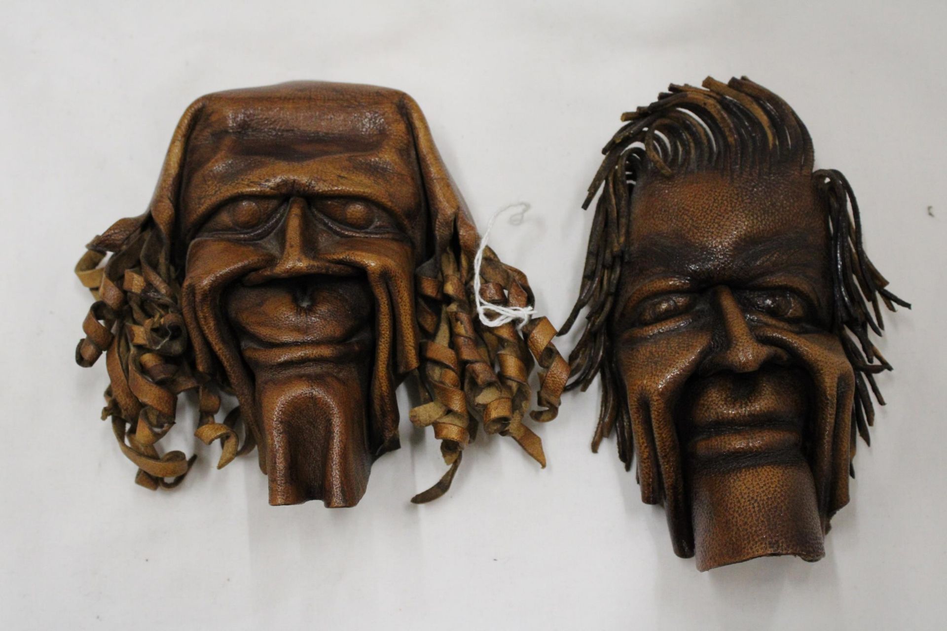 TWO VINTAGE SHAMAN ART STYLE LEATHER WALL MASKS