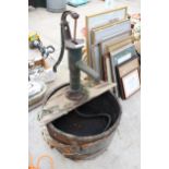 A VINTAGE WOODEN BARREL WATER FEATURE WITH VINTAGE CAST IRON WATER PUMP AND ELECTRIC PUMP