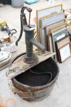 A VINTAGE WOODEN BARREL WATER FEATURE WITH VINTAGE CAST IRON WATER PUMP AND ELECTRIC PUMP