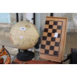 A RETRO ILLUMINATED GLOBE AND A FOLDING CHESS BOARD