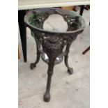 A CAST IRON PUB TABLE BASE WITH MASK AND FOLIATE DECORATION