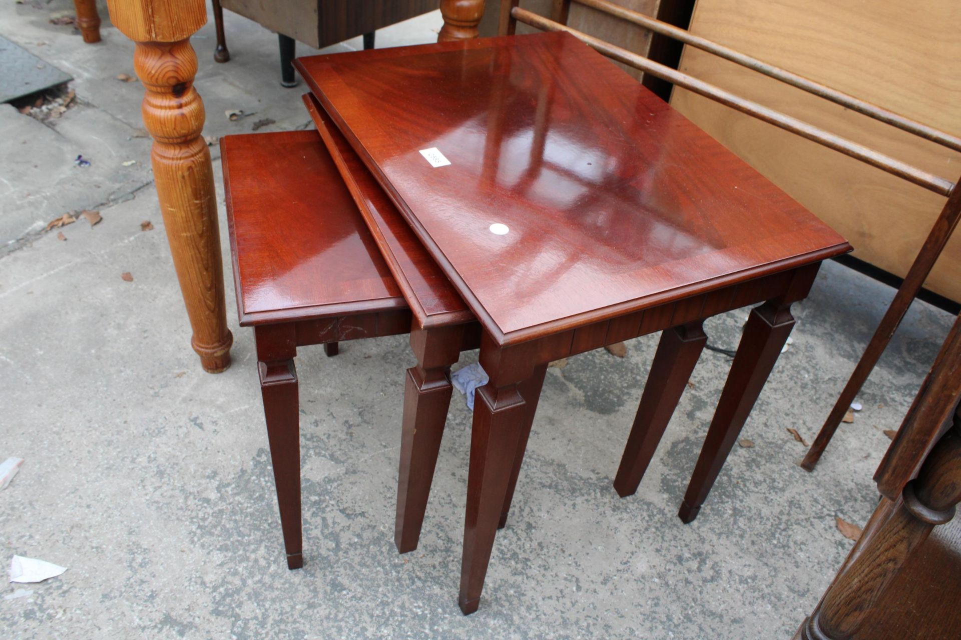 A NEST OF THREE MAHOGANY TABLES