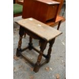 AN OAK JACOBEAN STYLE STOOL ON TURNED LEGS