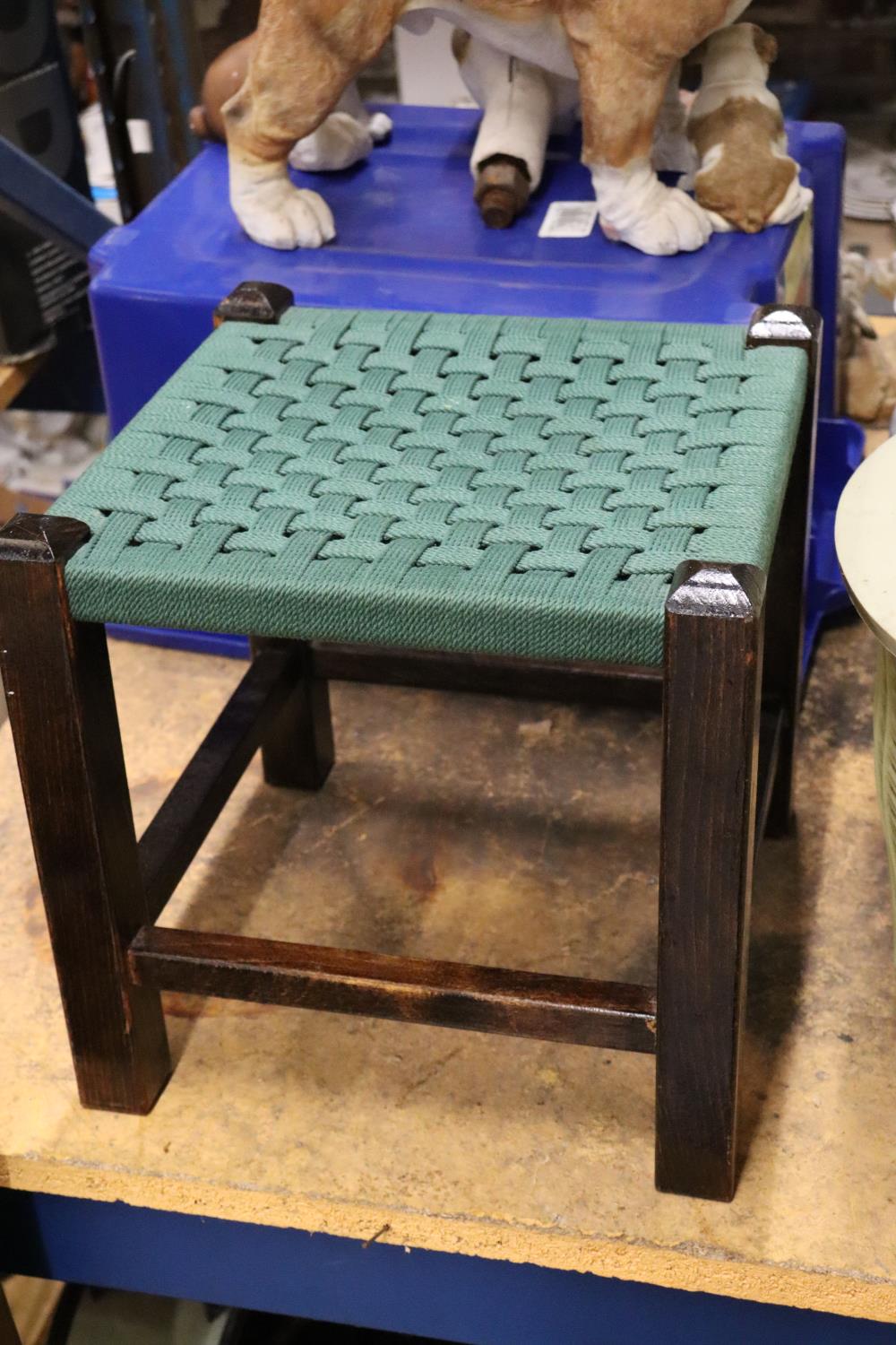 A VINTAGE FOOTSTOOL WITH GREEN WOVEN TOP