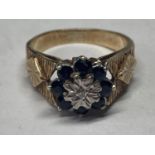 A 9 CARAT GOLD RING WITH CENTRE DIAMOND SURROUNDED BY SAPPHIRES SIZE J