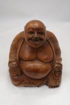 A LARGE WOODEN HAND CARVED BUDDHA