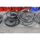 A LARGE ASSORTMENT OF VARIOUS BIKE WHEELS AND TYRES