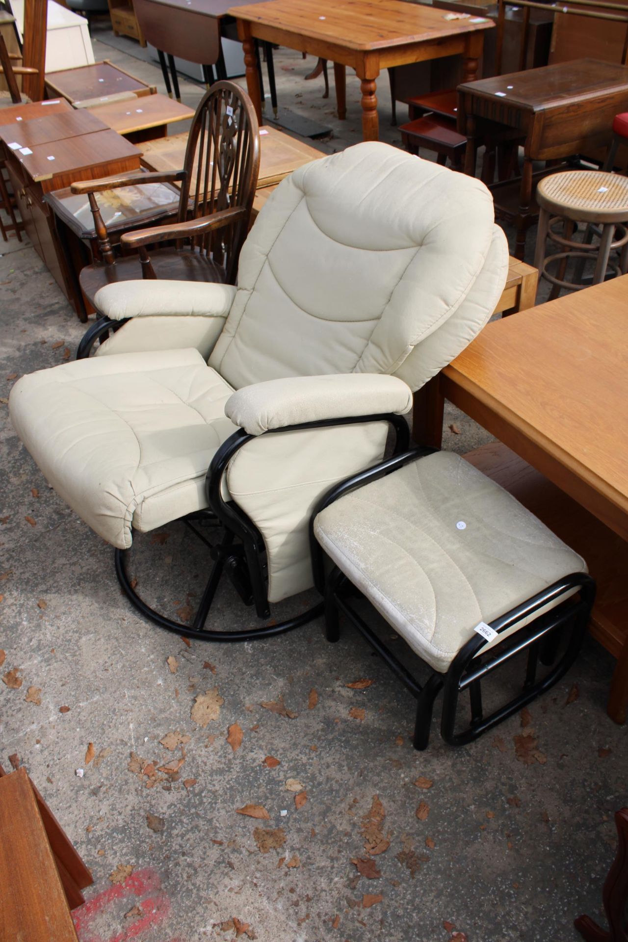 A MODERN ROCKER RECLINER AND STOOL BY THE PREMIER COMPANY (UK) LTD
