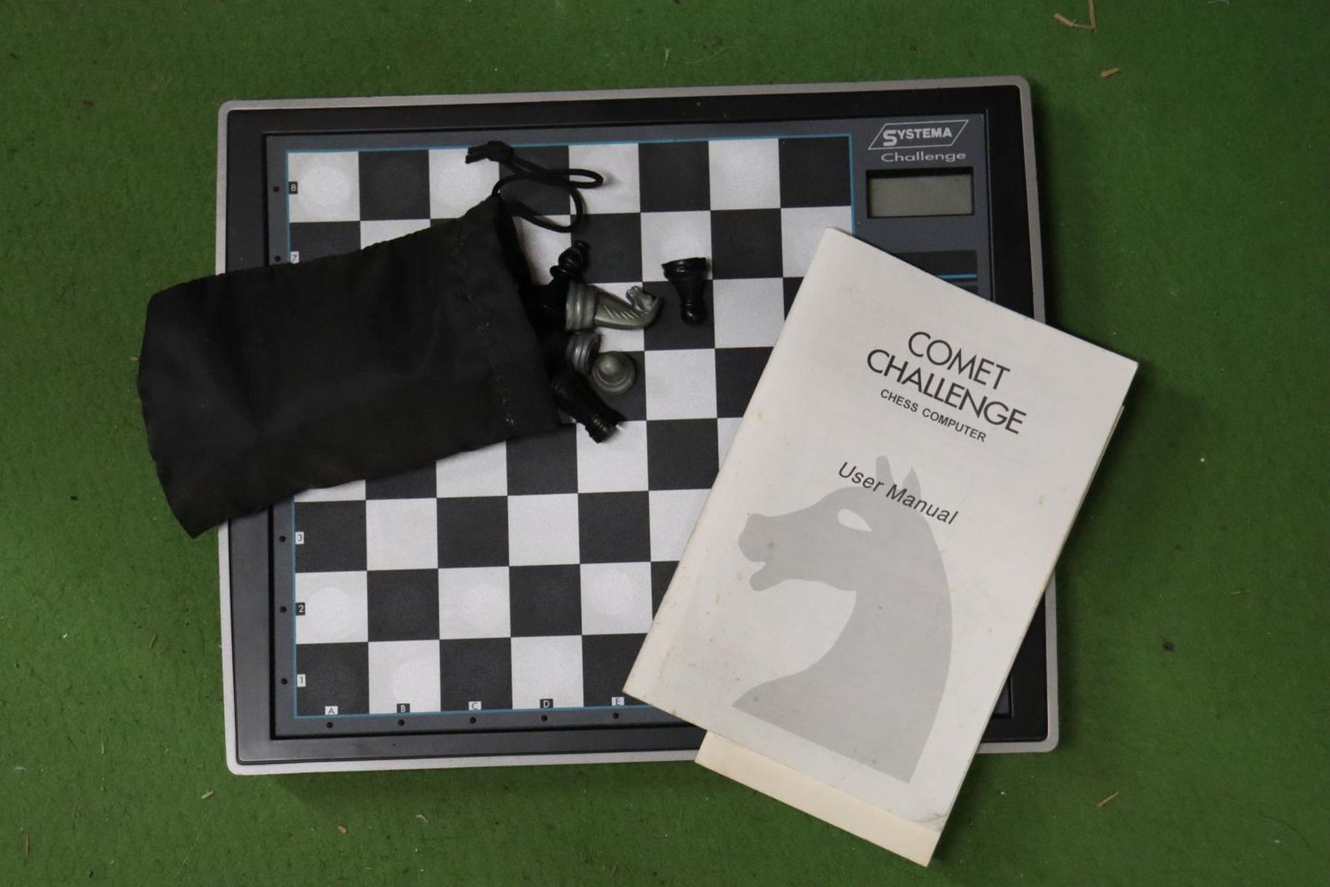A COMET CHALLENGE CHESS COMPUTER WITH MANUAL