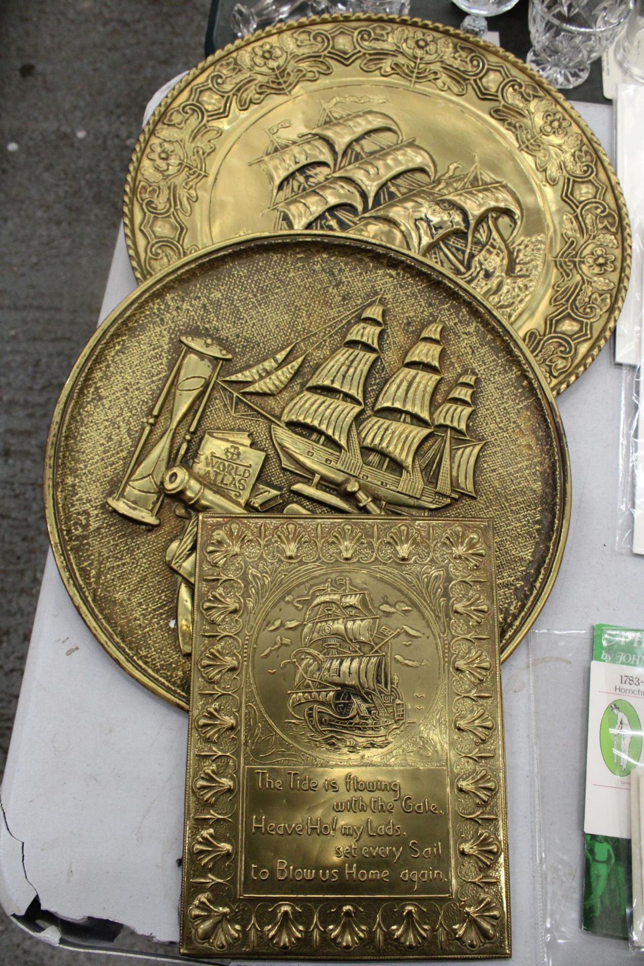 TWO LARGE BRASS VINTAGE WALL PLAQUES WITH SHIP DECORATION, DIAMETER 36CM PLUS A RECTANGULAR WALL