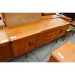 A TEAK BEAUTILITY SIDEBOARD ENCLOSING FOUR DRAERS AND TWO CUPBOARDS, 72" WIDE