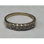 A 9 CARAT GOLD RING WITH SEVEN IN LINE CUBIC ZIRCONIAS SIZE Q/R