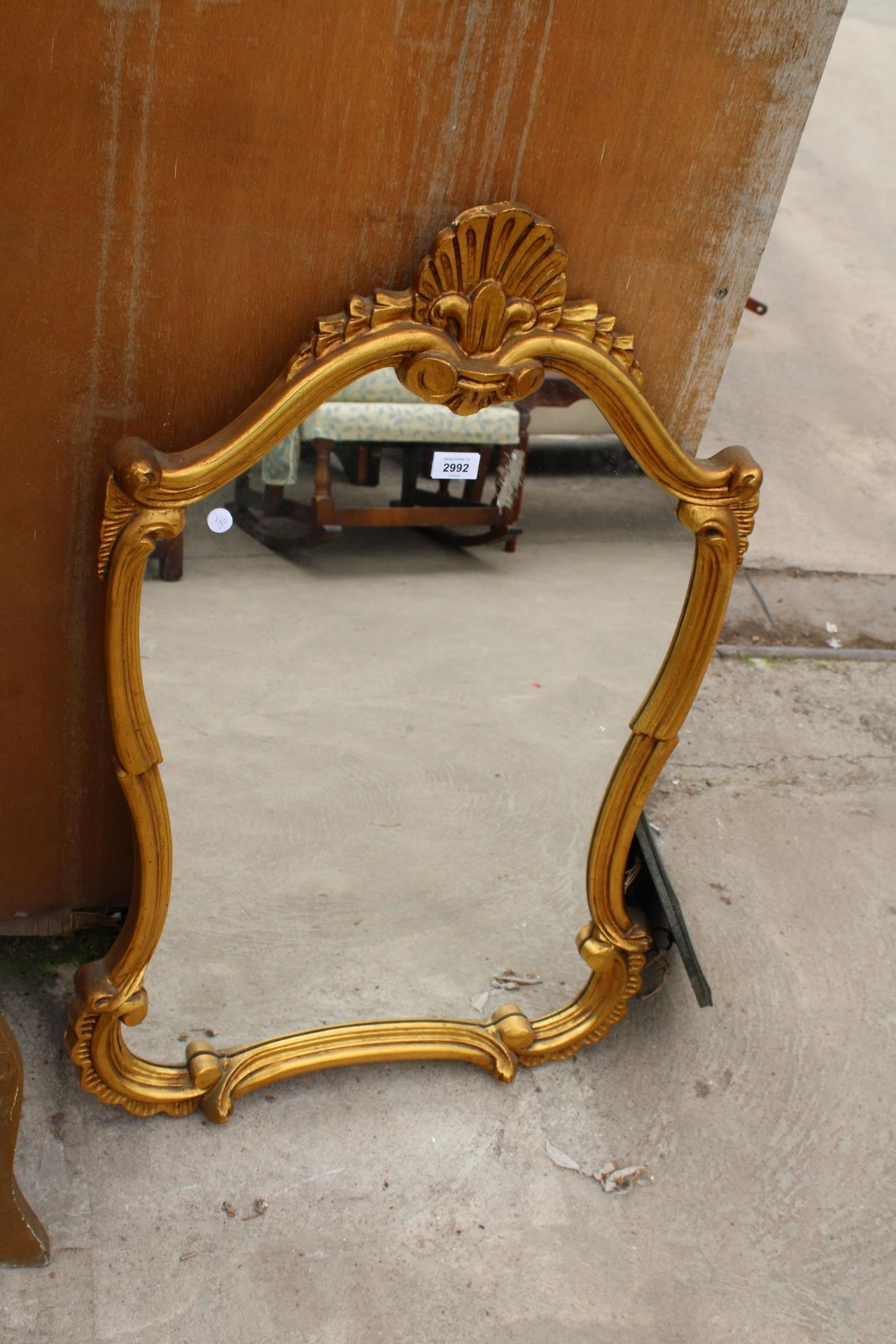 A GILT FRAMED WALL MIRROR, 35" X 24"