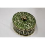 A GREEN ENAMELLED KEEPSAKE/JEWELLERY BOX WITH A JEWELLED FRONG ON THE LID, HEIGHT 8CM, DIAMETER,