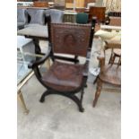 A VICTORIAN CROSS FRAMED ELBOW CHAIR WITH EMBOSSED LEATHER BACK AND SEAT