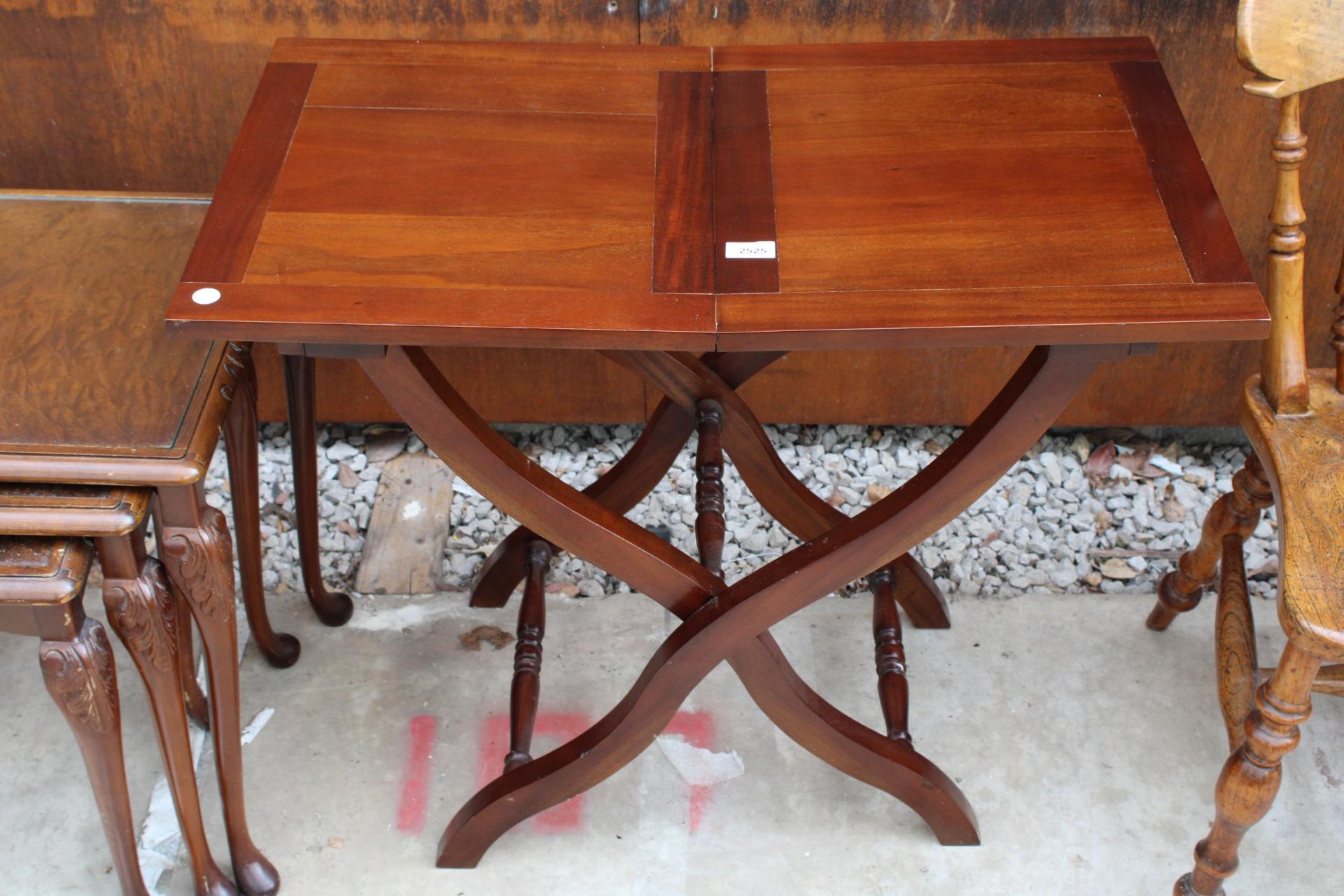 A REPRODUCTION HARDWOOD CROSS FRAME CAMPAIGN STYLE TABLE