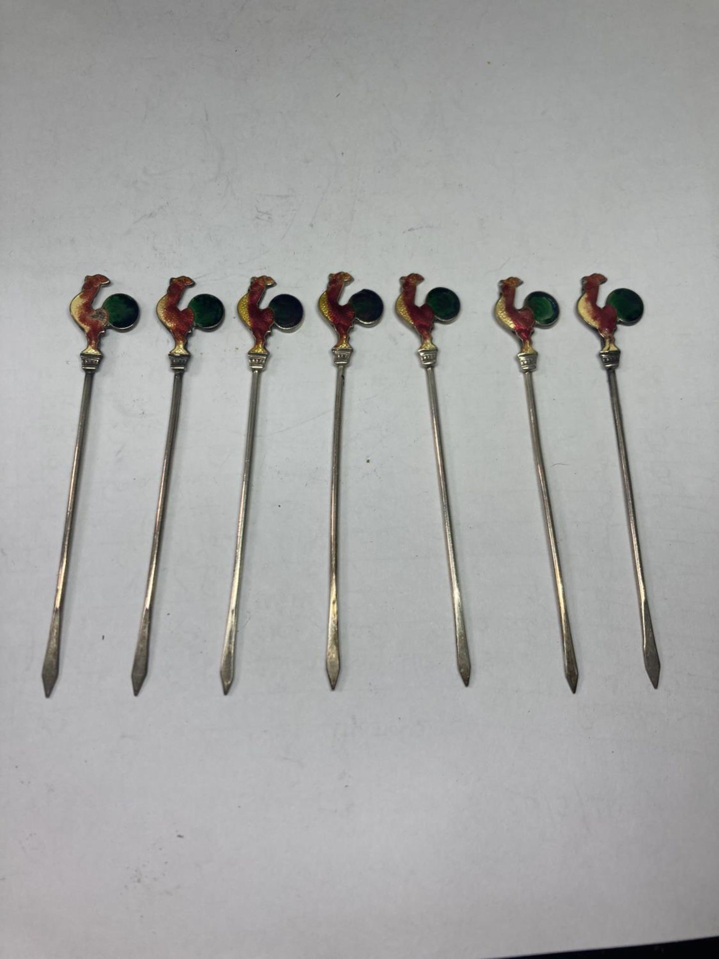 A SET OF SEVEN MARKED SILVER COCKTAIL STICKS WITH COCKEREL DESIGN