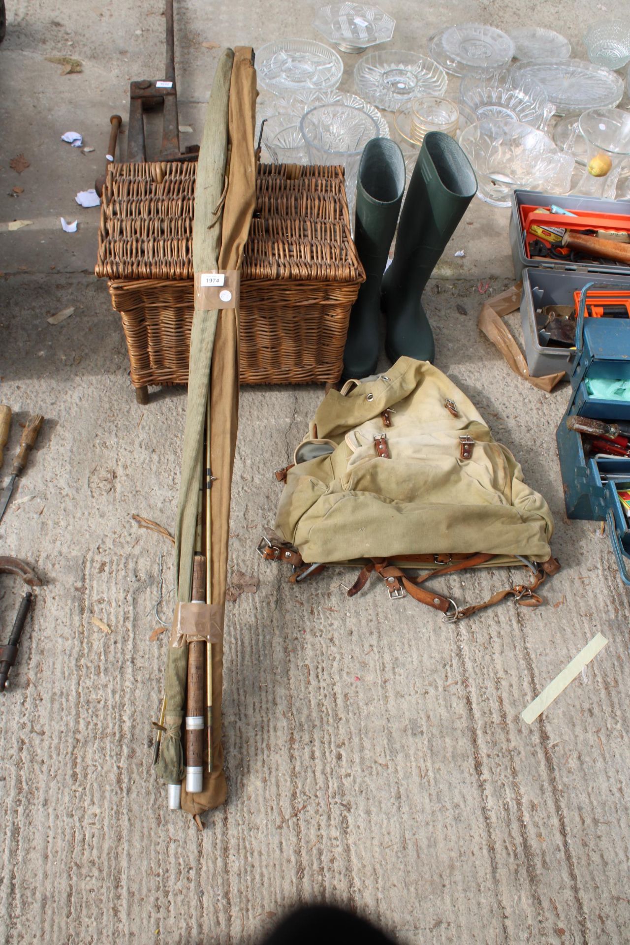 AN ASSORTMENT OF FISHING ITEMS TO INCLUDE RODS, A TACKLE BAG AND A WICKER TACKLE BOX ETC