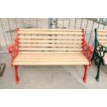 A WOODEN SLATTED GARDEN BENCH WITH DECORATIVE CAST ENDS