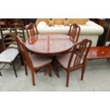 A MODERN POLISHED 42" DIAMETER DINING TABLE AND FOUR CHAIRS