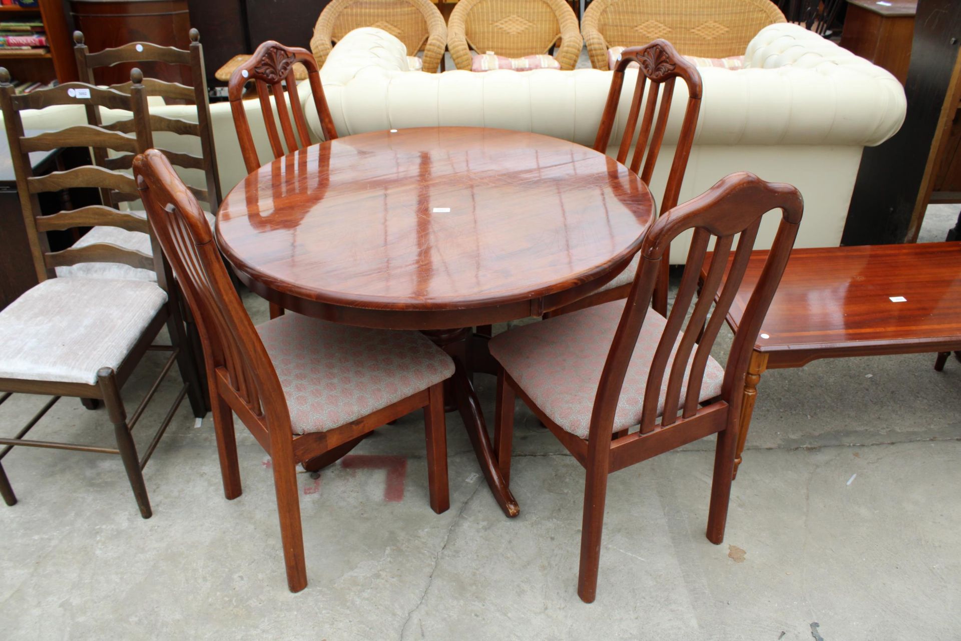 A MODERN POLISHED 42" DIAMETER DINING TABLE AND FOUR CHAIRS