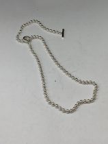 A SILVER T BAR NECKLACE