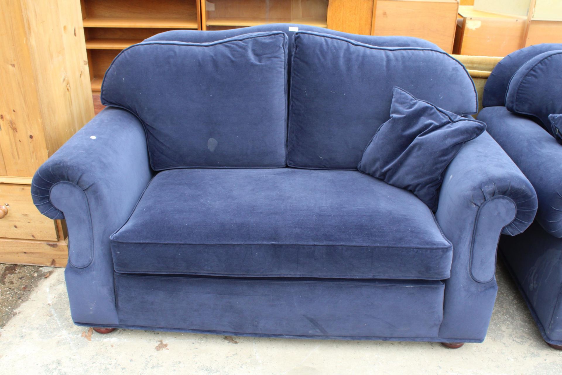 A MODERN BLUE TWO SEATER SETTEE WITH SPRUNG EDGE