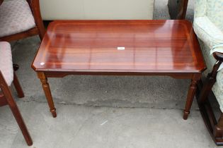 A MODERN POLISHED HARDWOOD COFFEE TABLE WITH CANTED CORNERS ON TURNED AND FLUTED LEGS, 37" X 20"