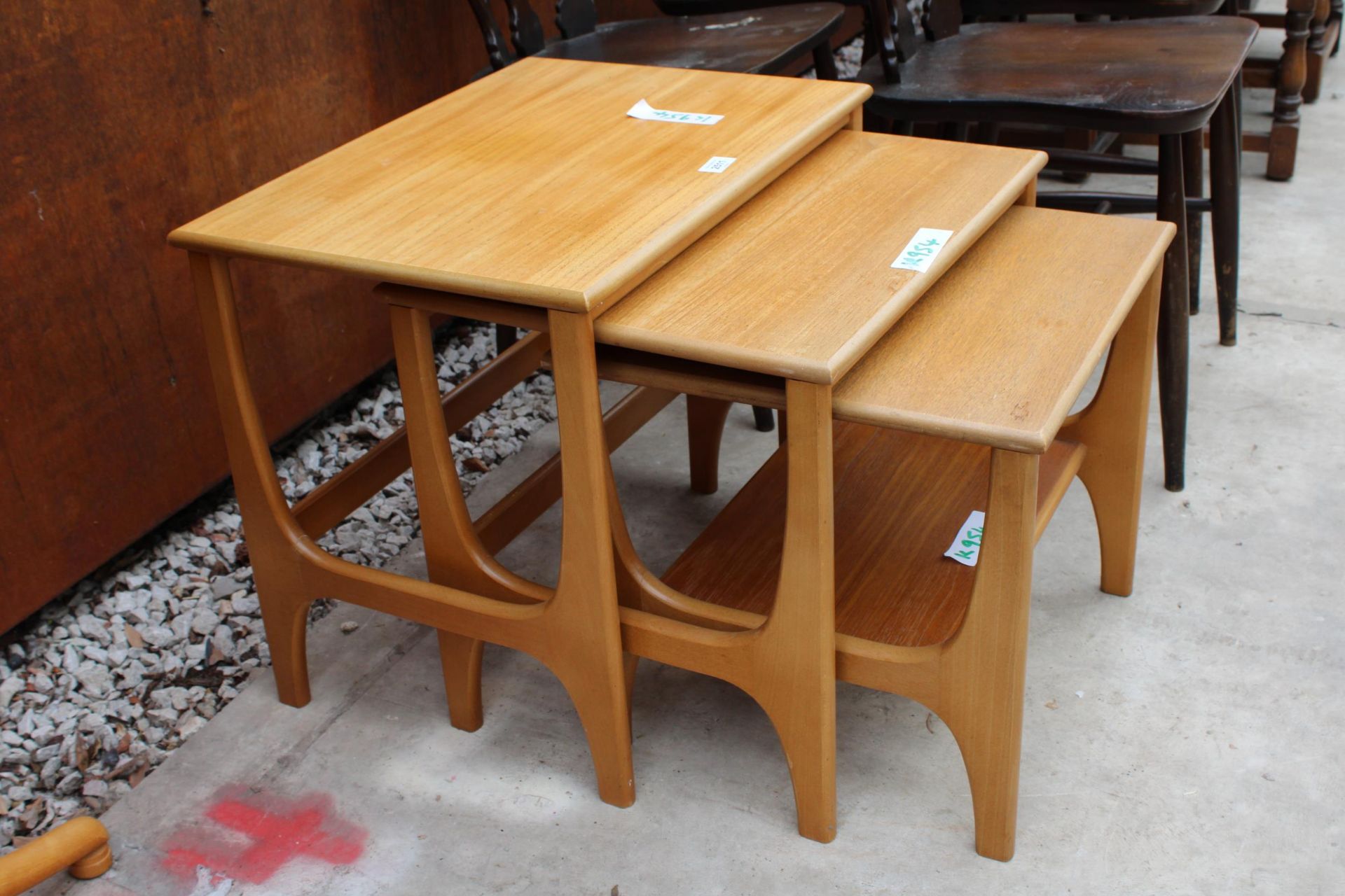 A RETRO TEAK NEST OF THREE TABLES