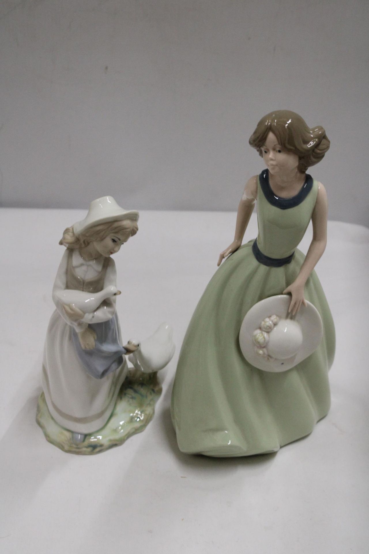 TWO SPANISH LADY FIGURES - TENGRA A GIRL WITH GEESE AND A NADEL FIGURE GIRL HOLDING A HAT